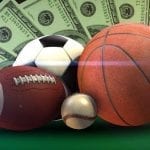 sports balls with money next to them