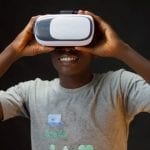 a man holding the vr headset that's on his head