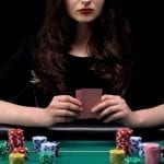 a woman holding her playing cards